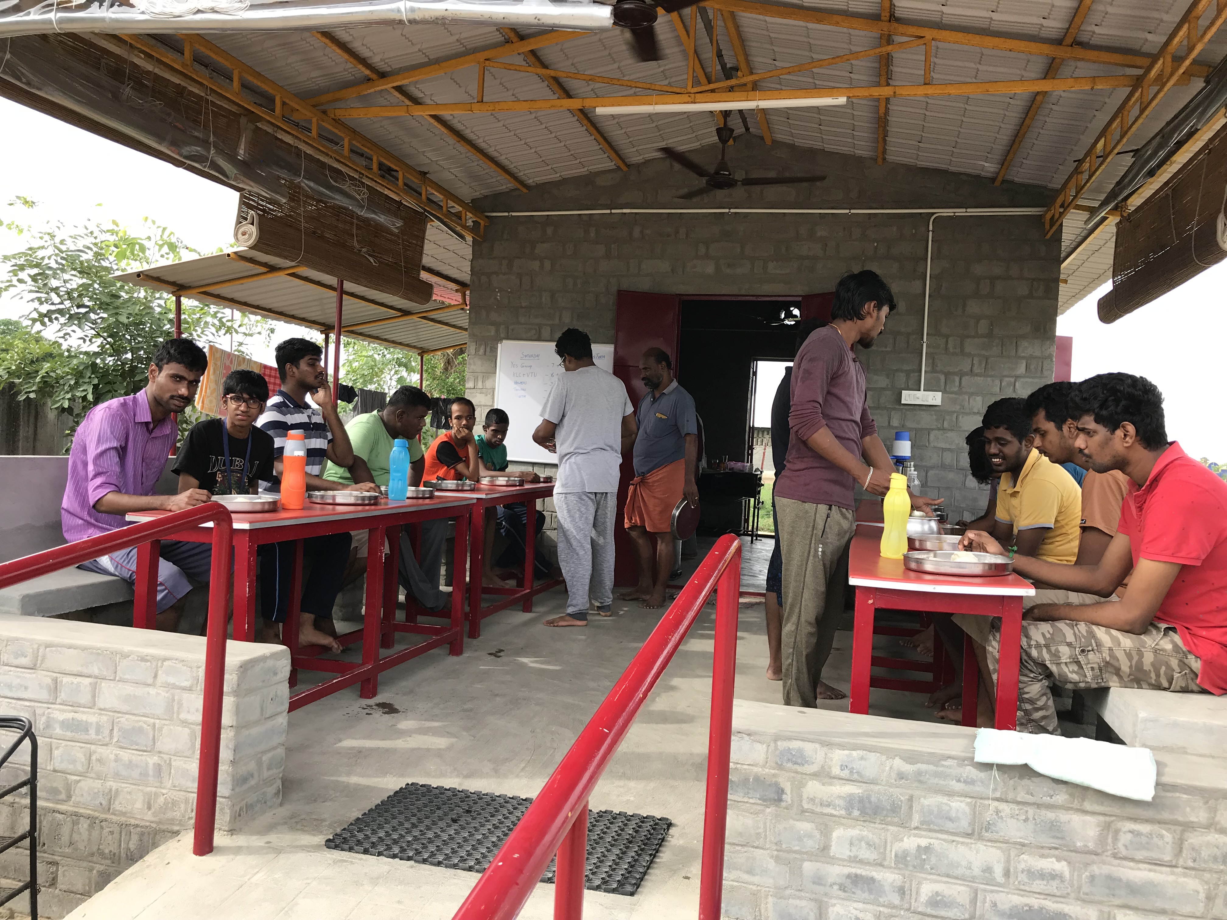 Two people practicing yoga outdoors in a scenic field at Sreyes Farm